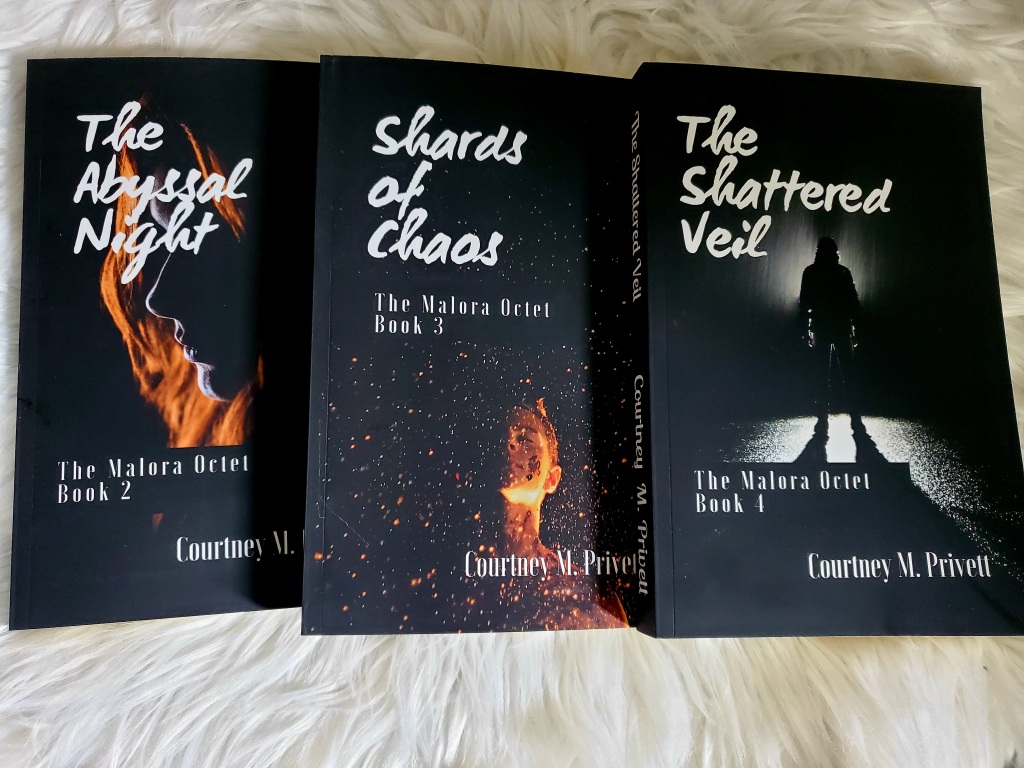 The paperback books for The Abyssal Night, Shards of Chaos, and The Shattered Veil, books 2-4 of The Malora Octet by Courtney M. Privett